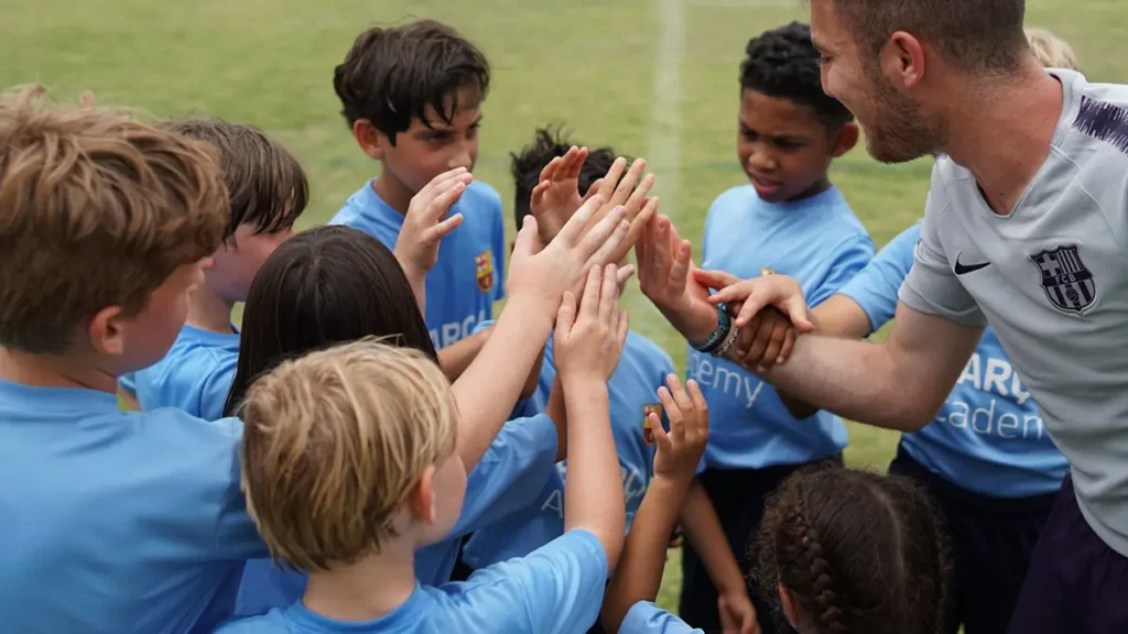 Coach group high fiving soccer youth athletes